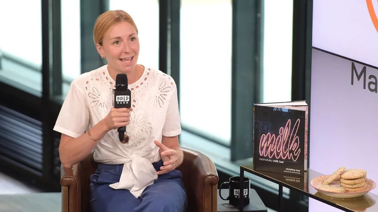Christina Tosi with microphone next to "milk" book