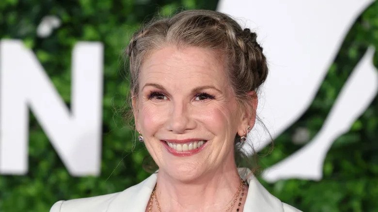 Melissa Gilbert rocking some milk maid braids and a soft pink lip while smiling on the red carpet