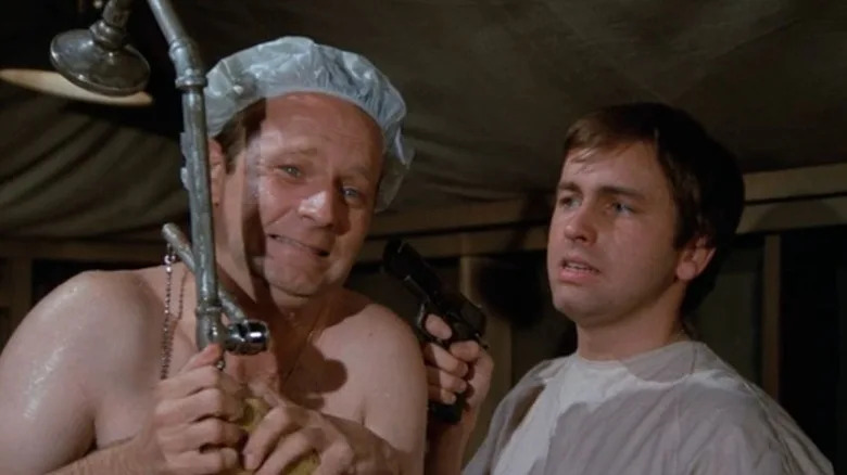 John Ritter appearing on an episode of M*A*S*H, holding a gun