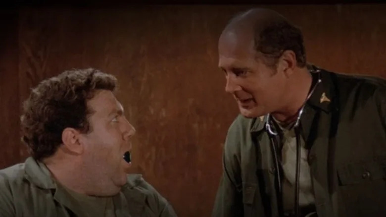 George Wendt appearing on an episode of M*A*S*H, with a pool ball in his mouth