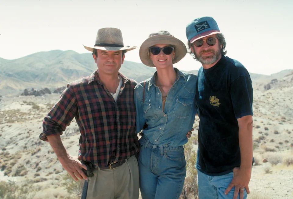 Sam Neill and Laura Dern pose wit Steven Spielberg in a publicity still for the film Jurassic Park.