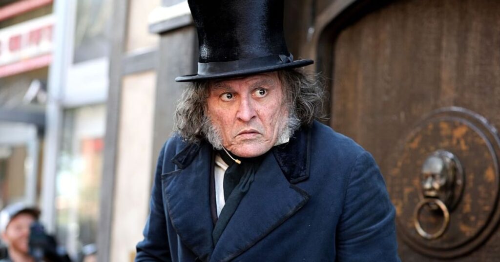 Johnny Depp, dressed as Ebenezer Scrooge, surprises Comic