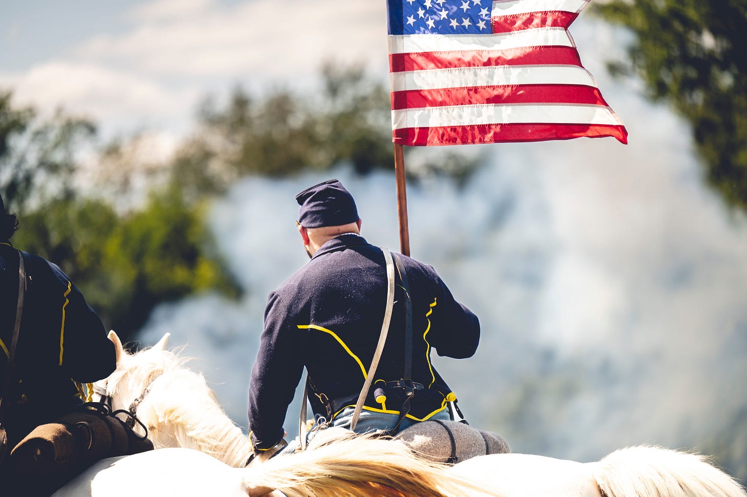 A Confederate soldier holding an American flag