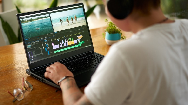 a person working on gaming laptop while in a vacation house