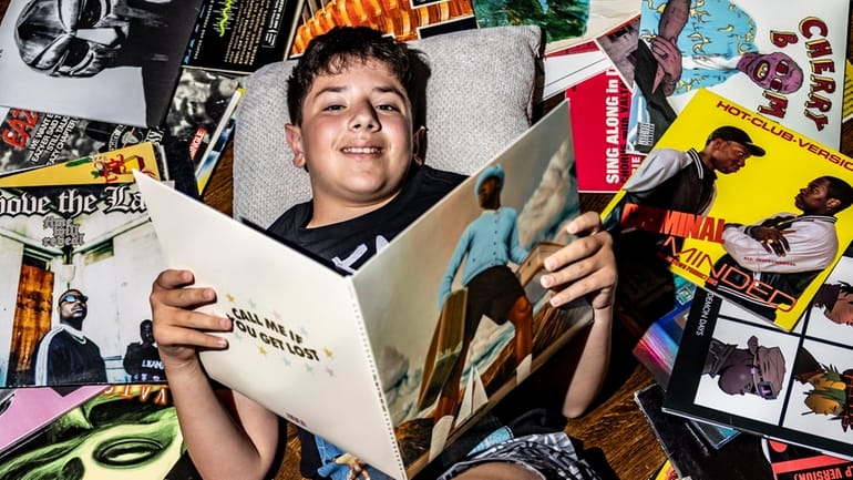 Gennaro Vigliotti, 11, sifts through his vinyl record collection at...