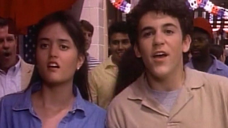 Danica McKellar and Fred Savage as Winnie and Kevin, standing with each other outside in The Wonder Years.