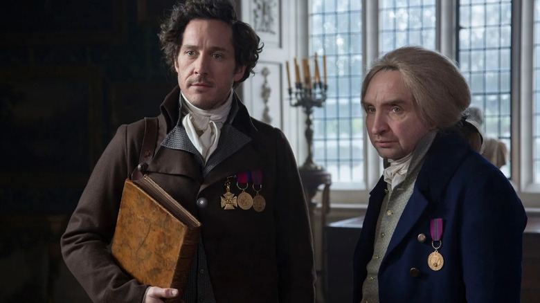 Bertie Carvel as Jonathan Strange and Eddie Marsan as Gilbert Norrell standing side by side in Jonathan Strange and Mr. Norrell.