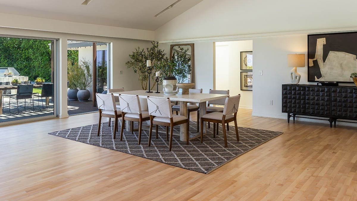 A dining room with a table large enough for eight guests.