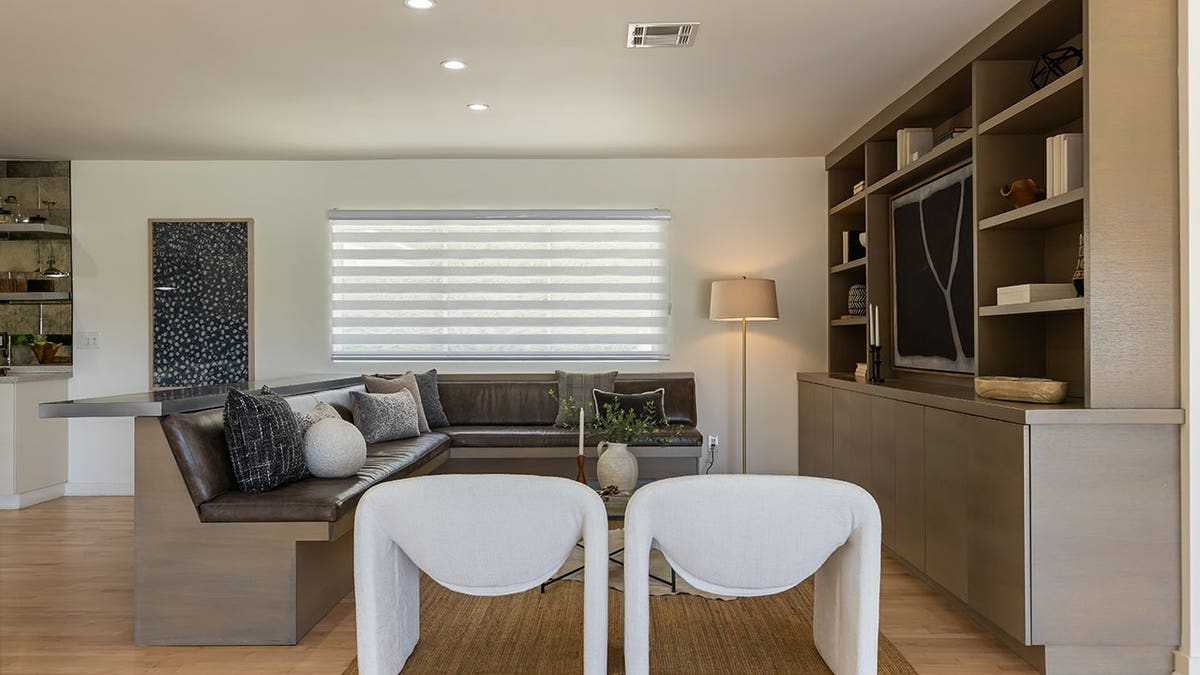 A sitting area with built-in bookshelves.