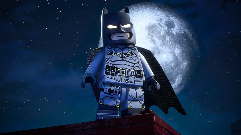 LEGO Batman stands framed by the full moon in LEGO Batman: Legacy of the Dark Knight