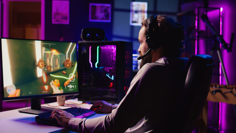 Person playing a FPS game on their PC