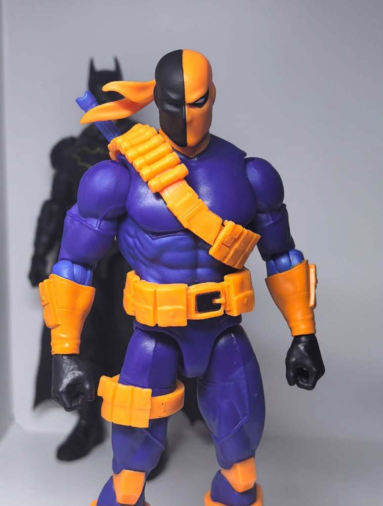 Full body in person view of the Mattel Deathstroke action figure with sword and utility belt