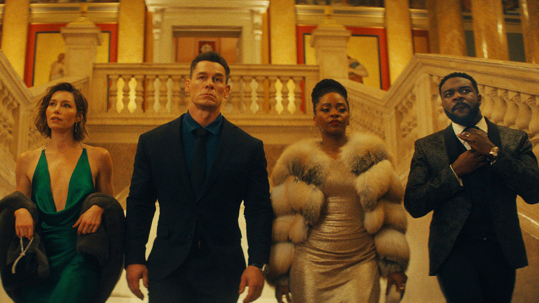 Jessica Biel, John Cena's Sean, Teyonah Parris, and Sam Richardson walk towards camera in Matchbox The Movie