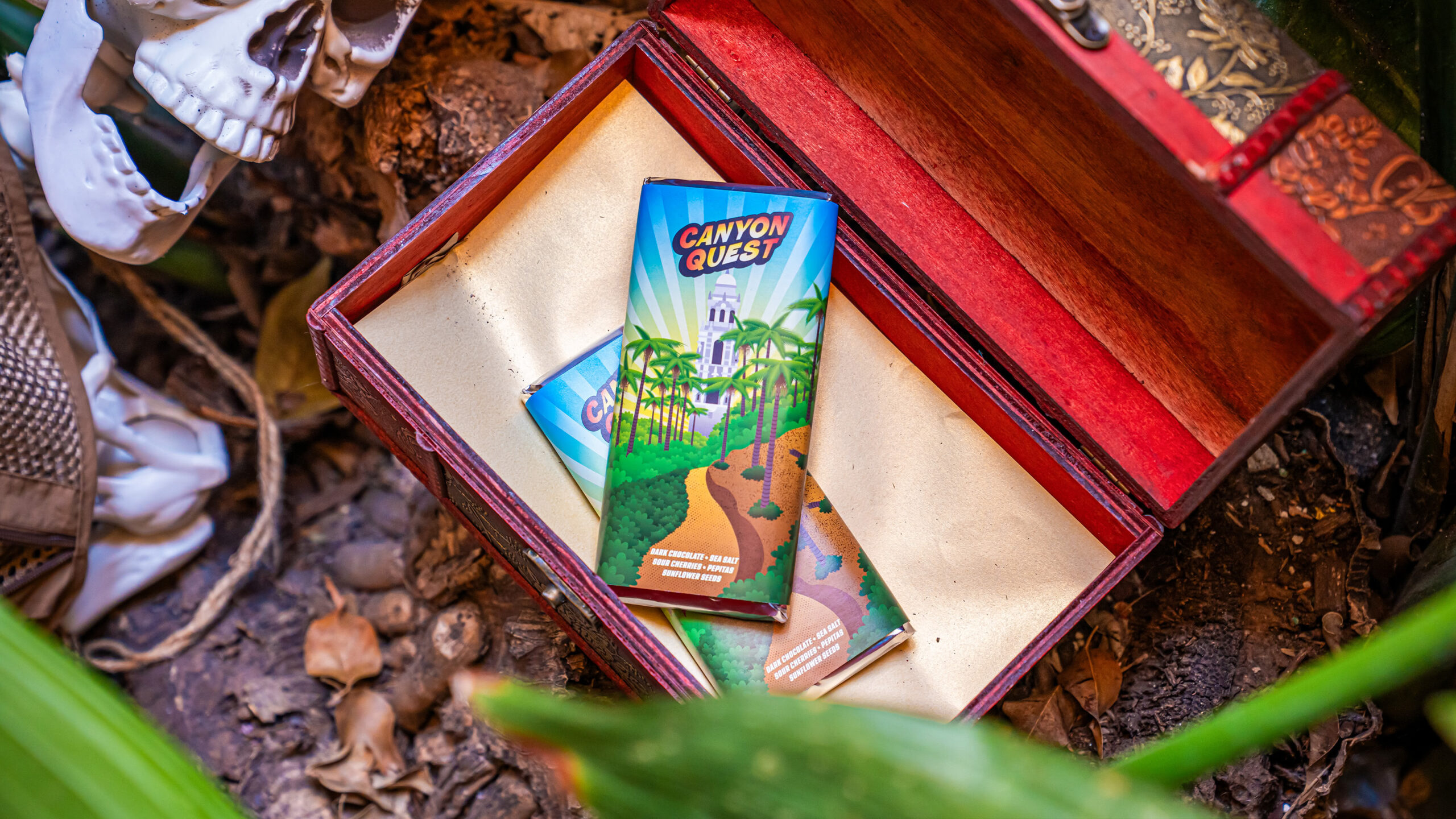 Canyon Quest limited-edition chocolate bars displayed inside an open wooden treasure chest for San Diego Comic-Con 2026