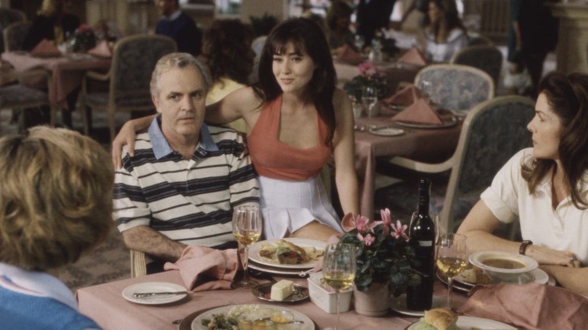 James Handy, Shannen Doherty and Lois Chiles stand together in a scene.