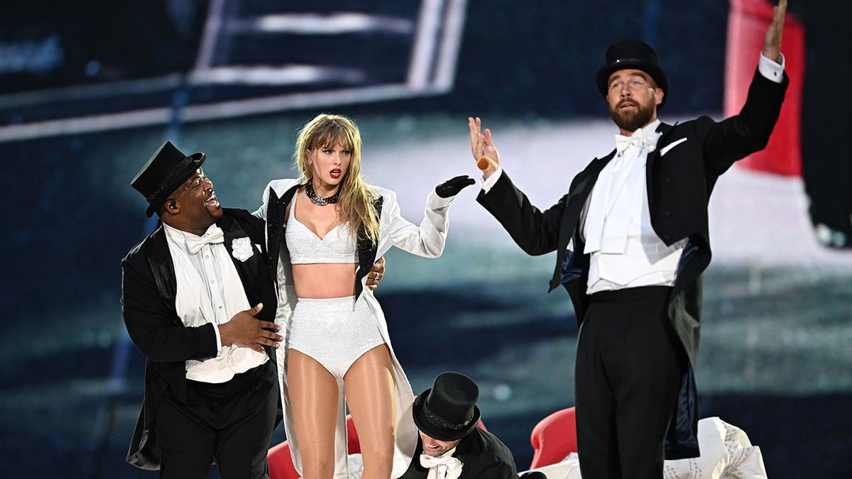 Taylor Swift and Travis Kelce on stage at the Eras Tour in London, England in June 2024.