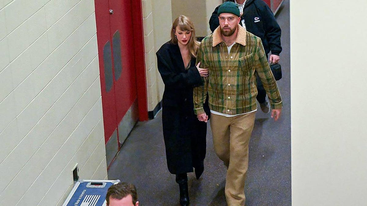 Taylor Swift and Travis Kelce leave Arrowhead Stadium in Kansas City in December 2023.