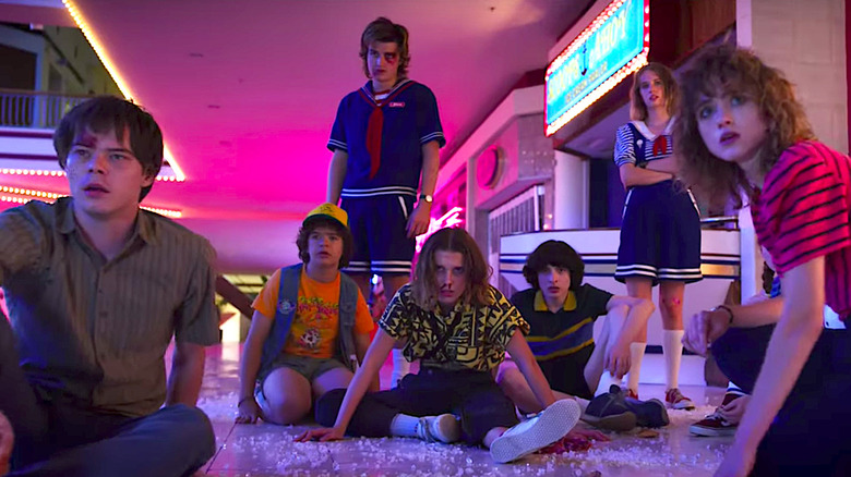 Several of the kids of Hawkins, collapsed on the floor in the aftermath of a battle in Stranger Things.