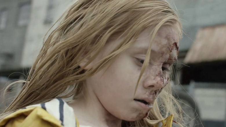 A close up of a zombie girl walking down a street in Dead Rising: Endgame