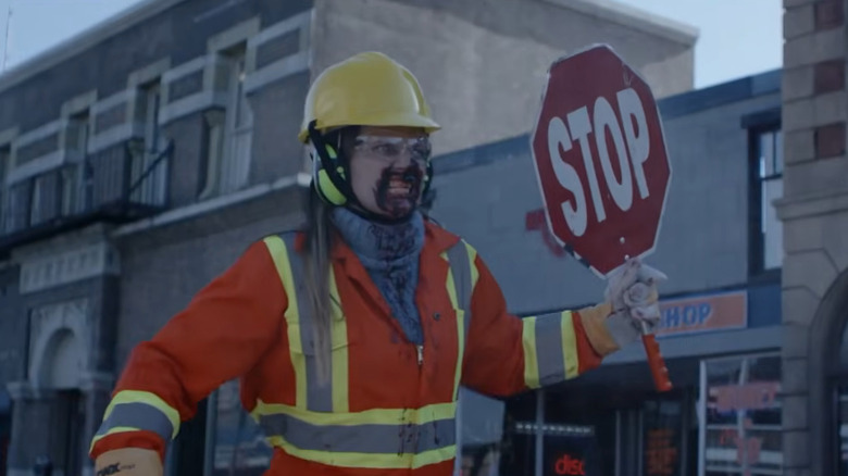 A zombie holding a stop sign in Dead Rising: Watchtower