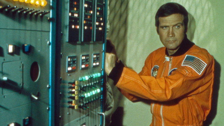 Steve Austin in a spacesuit standing near a switchboard in The Six Million Dollar Man (1973)