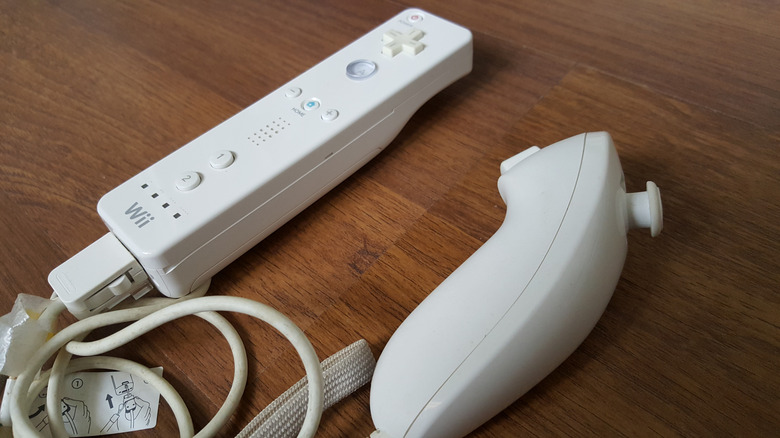 The Wii Remote and the Nunchuck on a wooden surface