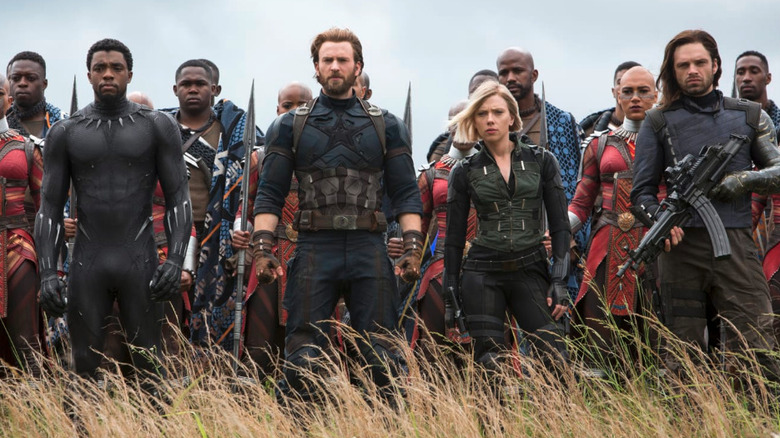Chris Evans as Steve Rogers/Captain America, Sebastian Stan as Bucky Barnes, Chadwick Boseman as T'Challa / Black Panther, Scarlett Johansson as Natasha Romanoff / Black Widow ready to fight in Avengers: Infinity War