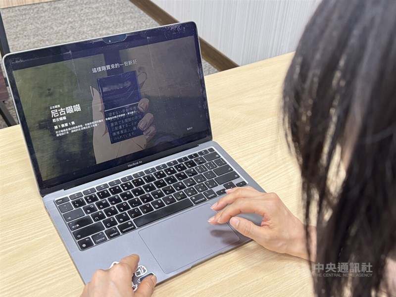 A person watches "Chainsmoker Cat" on a laptop in this CNA file photo