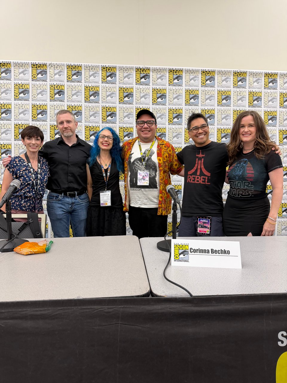 Barbra Dillon, Phillip Kennedy Johnson, Corinna Bechko, Henry Barajas, Arthur N. Ebuen, and Desiree Proctor at SDCC panel stage in front of SDCC step-n-repeat.