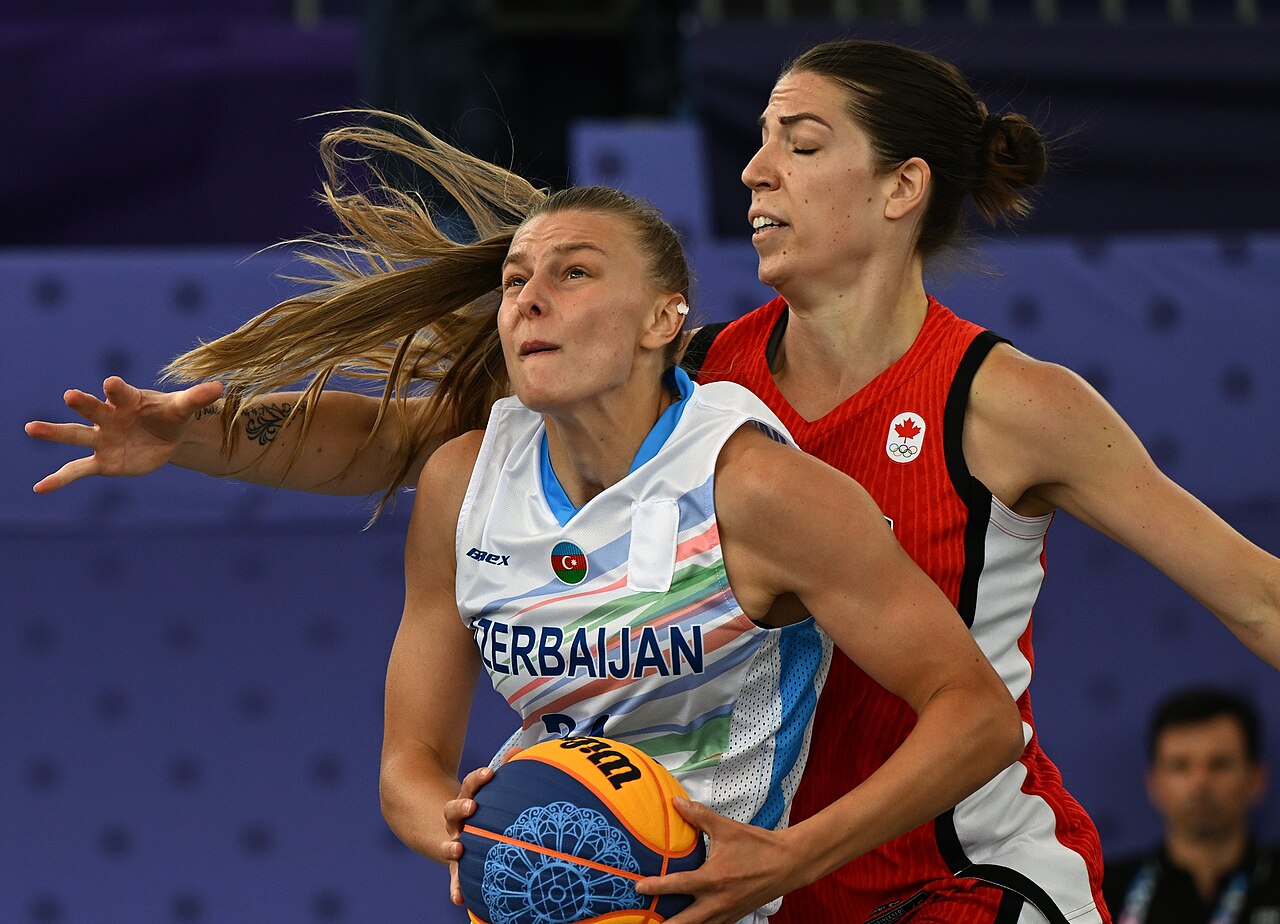 Azerbaijan and Canada players contest possession during a women's 3x3 basketball game at the 2024 Summer Olympics