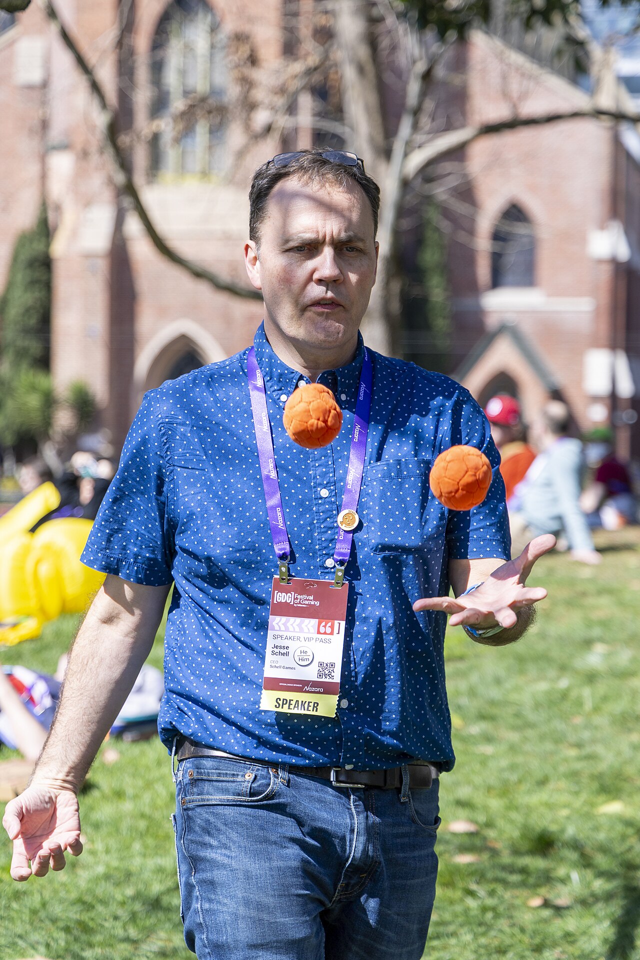 Jesse Schell juggling outside the 2026 Game Developers Conference, wearing a speaker badge that reads CEO, Schell Games