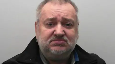 North Yorkshire Police Ian Mark Wrightson has short grey hair and a short grey stubble. He is wearing a black jacket, against a grey background.