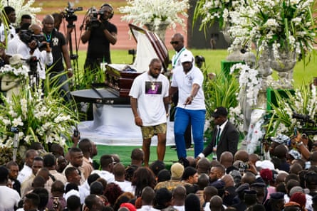 The Nigerian singer Davido (centre) leaves after paying his respects at the funeral ceremony for DJ Arafat at the Félix Houphouët-Boigny stadium in Abidjan in August 2019.