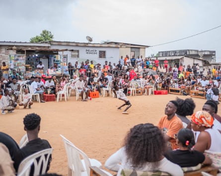 A dancer from Goodofwar Biama dance crew makes acrobatic moves in the middle of the crowd