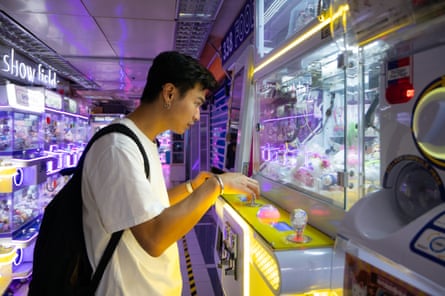 Jerry, 27, a property management officer, playing claw machines in Kwai Chung Plaza