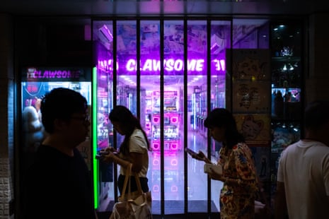 People playing claw machines in Mongkok, Hong Kong