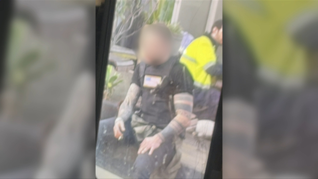 A man was seen in a bulletproof vest bearing an American flag.