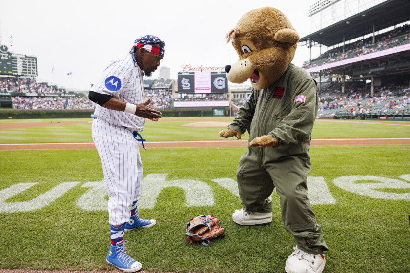 Mr. T and Clark the Cub dance during a baseball game between Chicago Cubs and the St. Louis Cardinals at Wrigley Field.