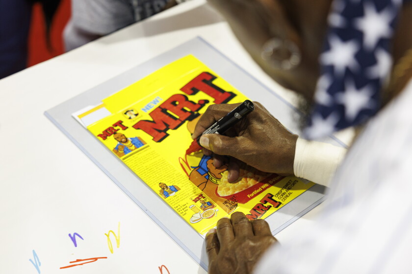 Mr. T signs autograph on fans photos and memorabilia during the Fan Expo Chicago.