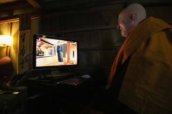 Zen Buddhist priest Roshi Jundo Cohen interacts with AI avatar Emi Jido at his Zen meditation hall in Tsukuba, Japan on Feb. 13, 2026. (AP Photo/Ayaka McGill)
