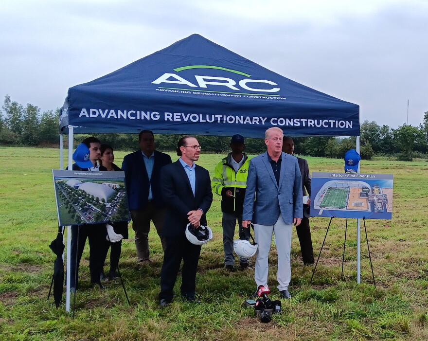 Dr. Brian McGrath, at right, speaks to open a groundbreaking ceremony for the 716 Sports Complex, a planned $50 million, 331,000-square-foot sports and entertainment center. At his left is Dr. Marc Fineberg, who with McGrath is a co-partner in the project.