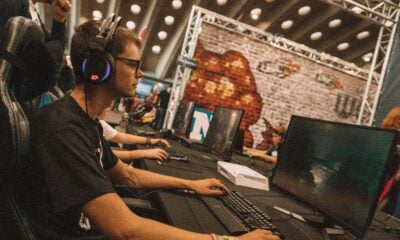 Esports player competing on a gaming PC during a live LAN tournament.