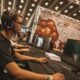 Esports player competing on a gaming PC during a live LAN tournament.