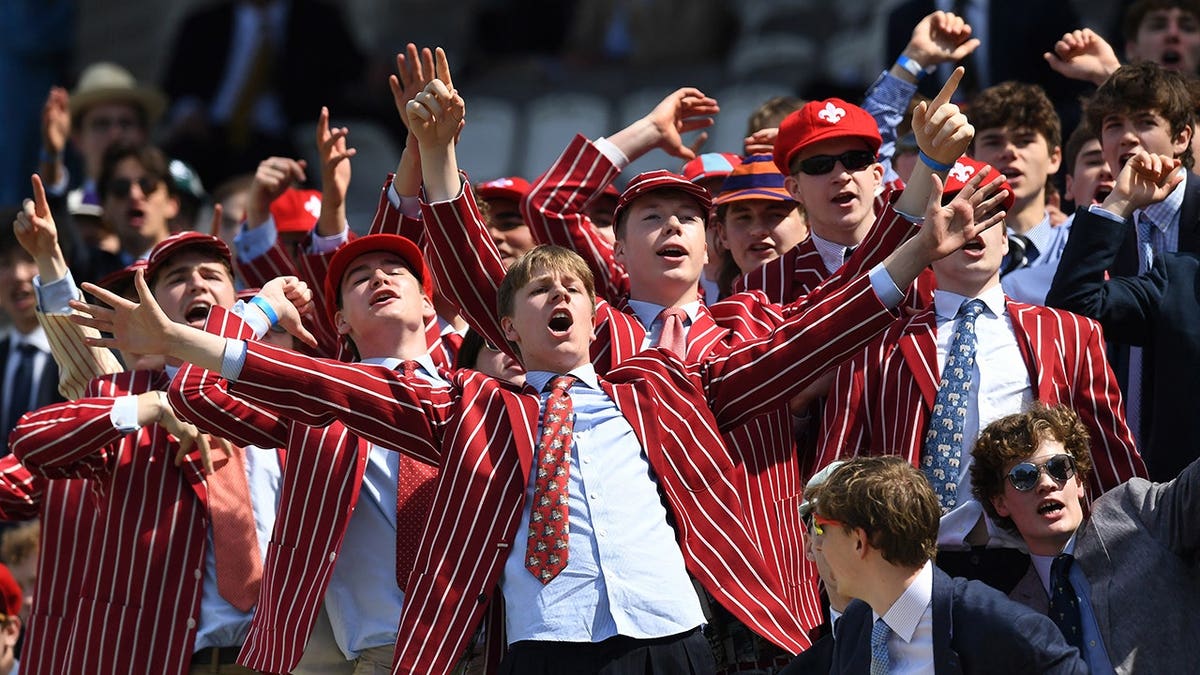 Students from Eton College react in the Mound Stand at Lord's Cricket Ground.
