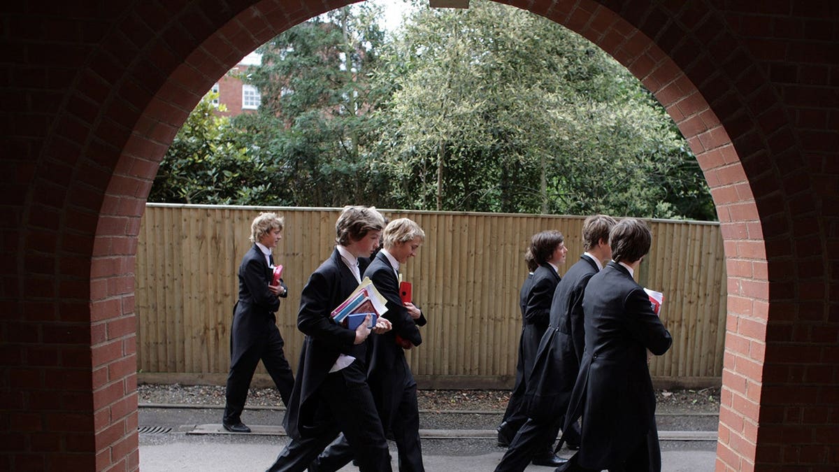 Boys walk to classes at Eton College in Eton, England.