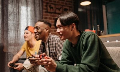 Friends playing video games on couch