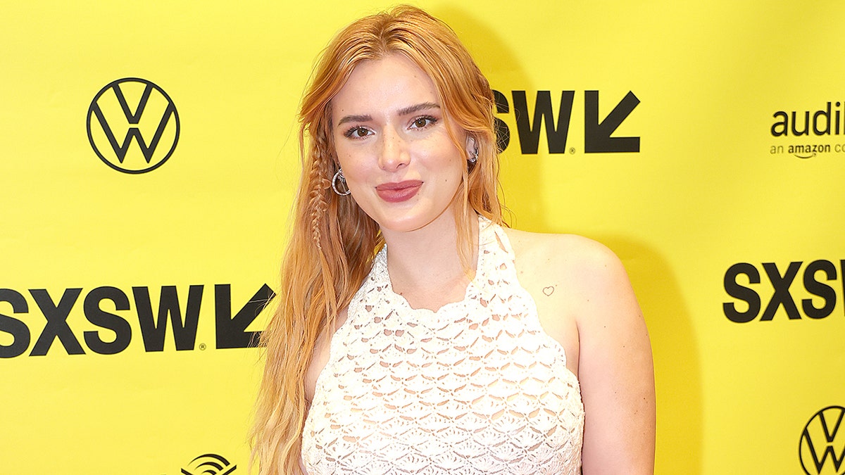 Bella Thorne in a crocheted cream dress on the red carpet
