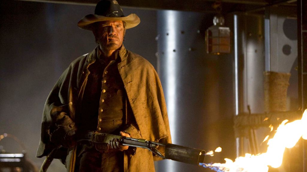 Josh Brolin as Jonah Hex using a flamethrower