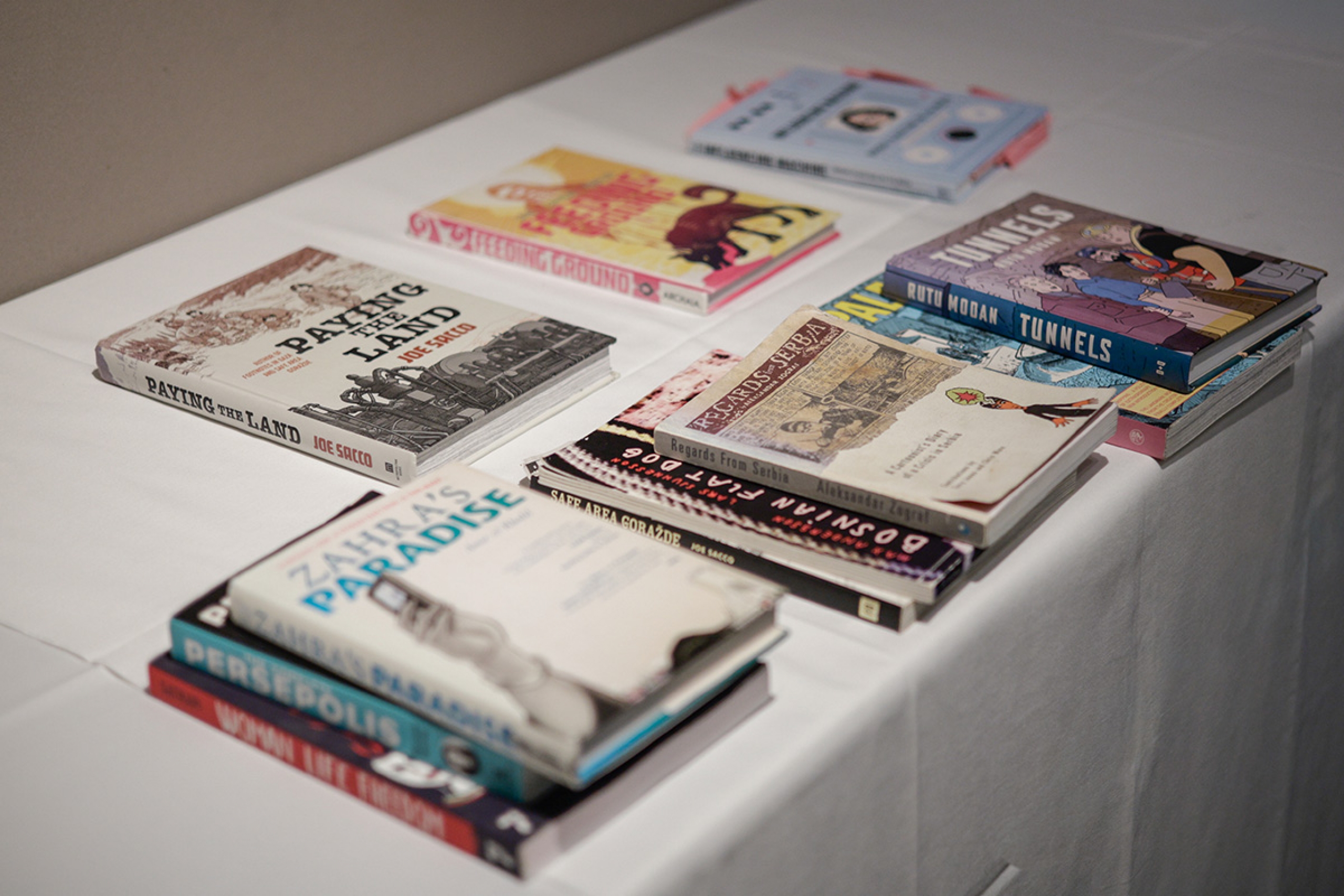 six books are displayed on a table