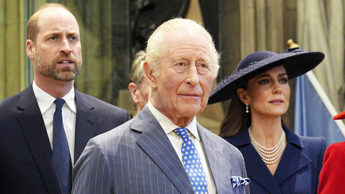 Prince William, King Charles and Kate Middleton standing together appearing serious in formal wear.